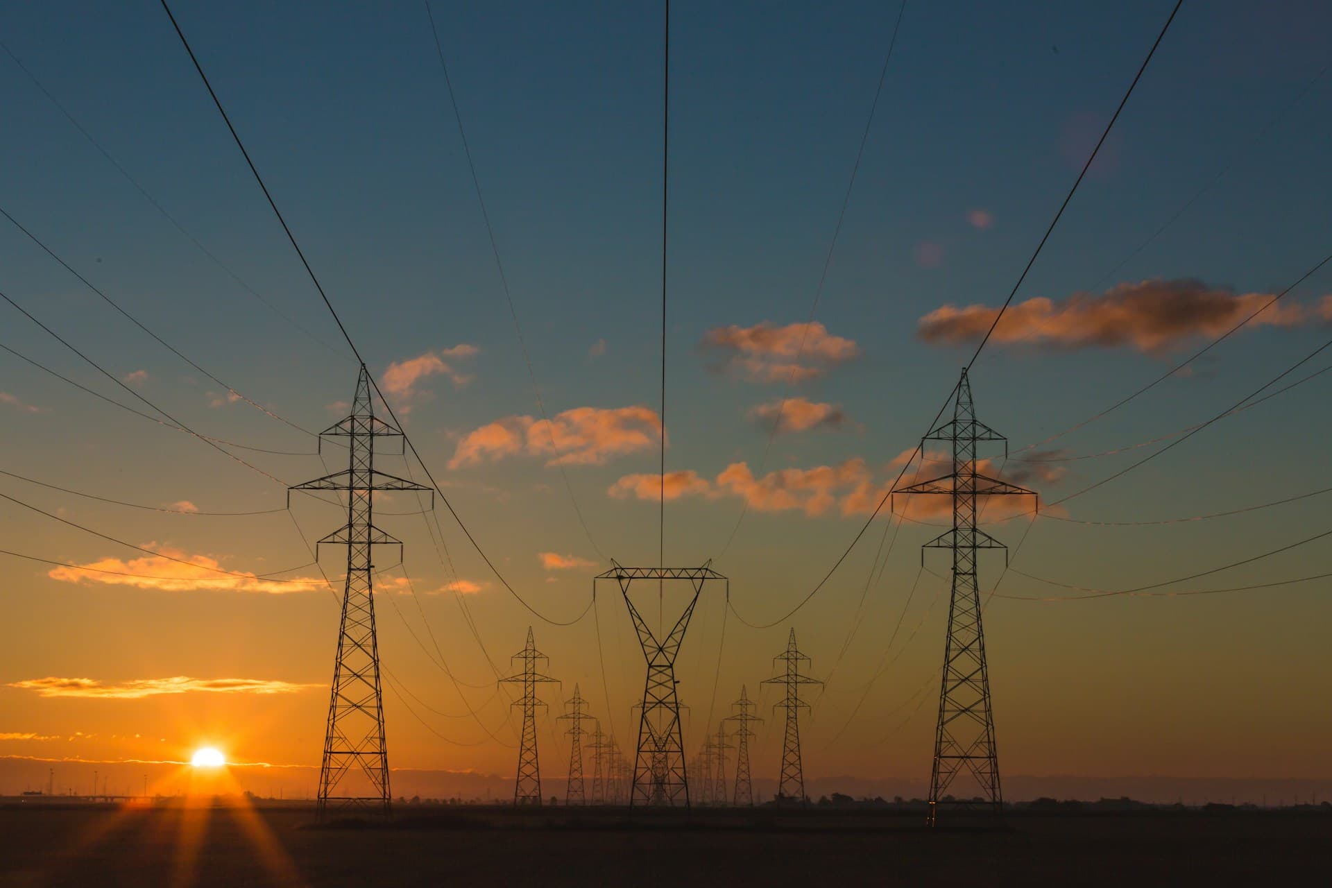 Electricity pylons at sunset — the end of one trading day and the start of the next